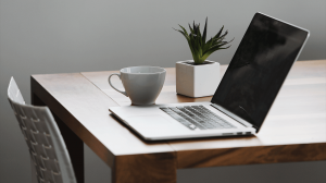 Meet Julia - Desk with laptop, coffee, and plant